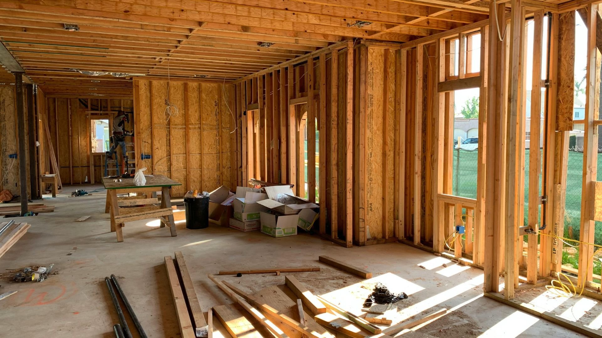 Interior of house under construction with wooden framing and construction materials